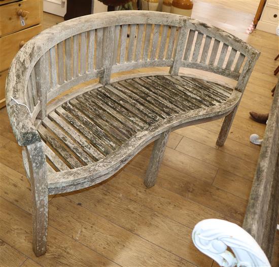 A weathered teak garden banana bench W.150cm